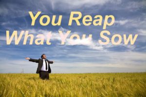 businessman with his arms wide open in rural field